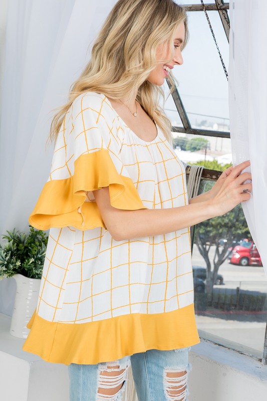 PLUS WOVEN PLAID AND SOLID JERSEY MIX RUFFLE PEASANT TOP- Plus Plaid mix ruffle peasant top- Short ruffled bell sleeves- Wear it off shoulder or as a loose scoop necCoeur de la Mode